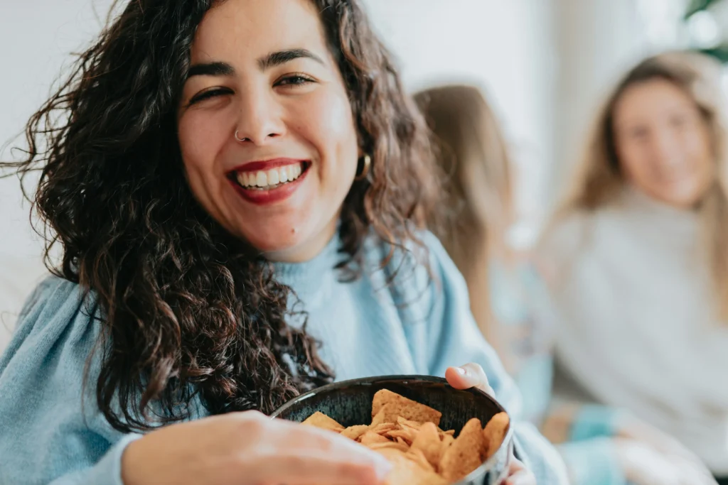 Woman shows bowl with chips